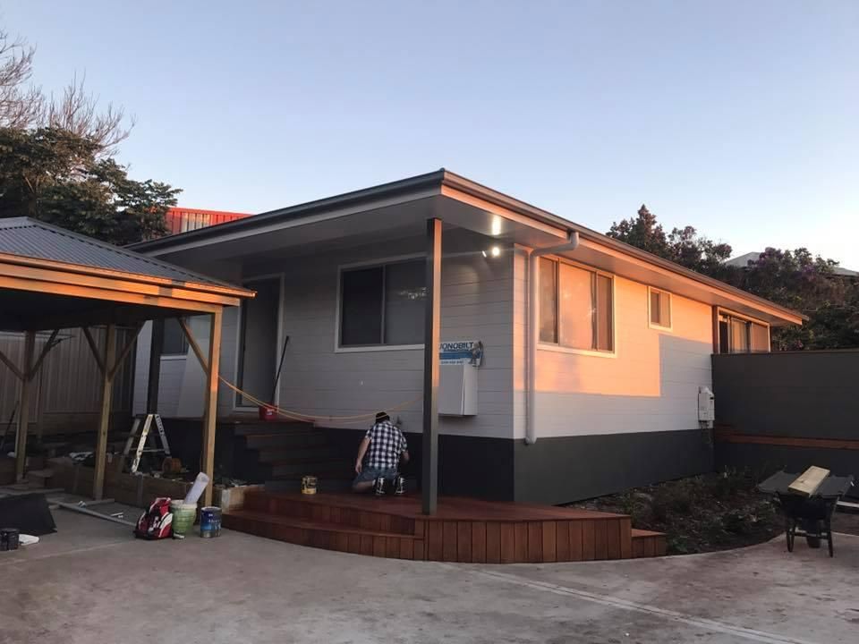 A Man Is Standing on A Porch in Front of A House — Jonobilt in Charlestown, NSW