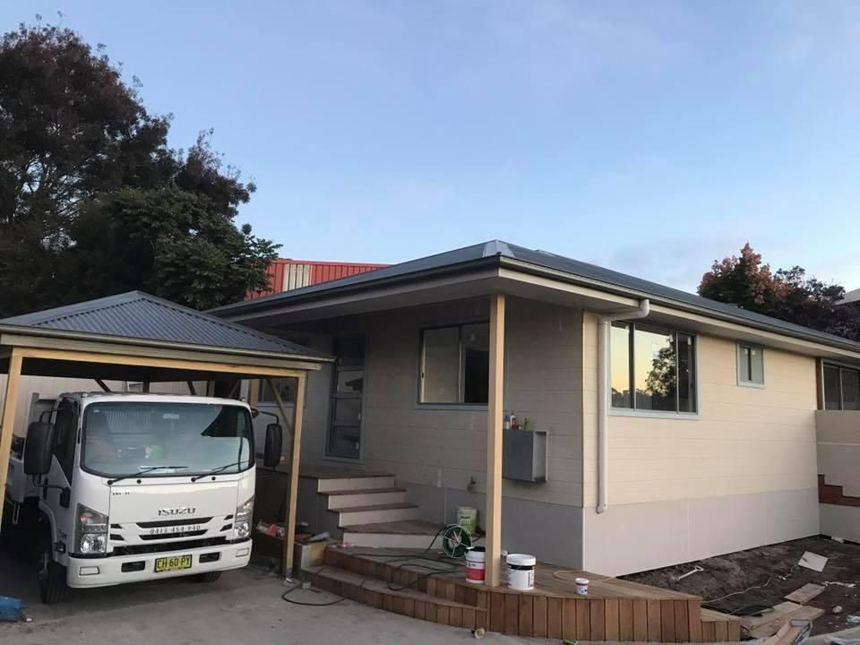 A White Truck Is Parked in Front of A House Under a Carport — Jonobilt in Merewether, NSW