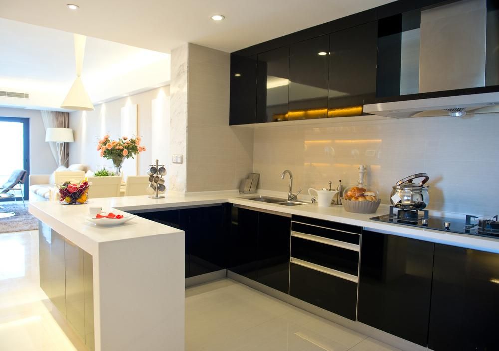 A Kitchen with Black Cabinets and White Counter Tops — Jonobilt in Charlestown, NSW