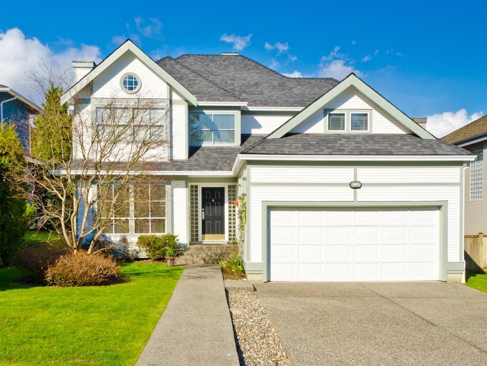 A Large White House with A Gray Roof and A White Garage Door — Jonobilt in Redhead, NSW
