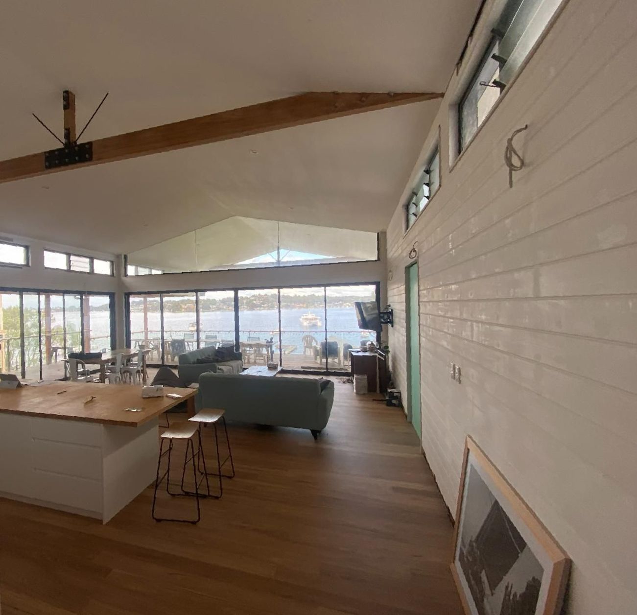A Living Room with A Lot of Windows and A Ceiling Fan — Jonobilt in Newcastle, NSW