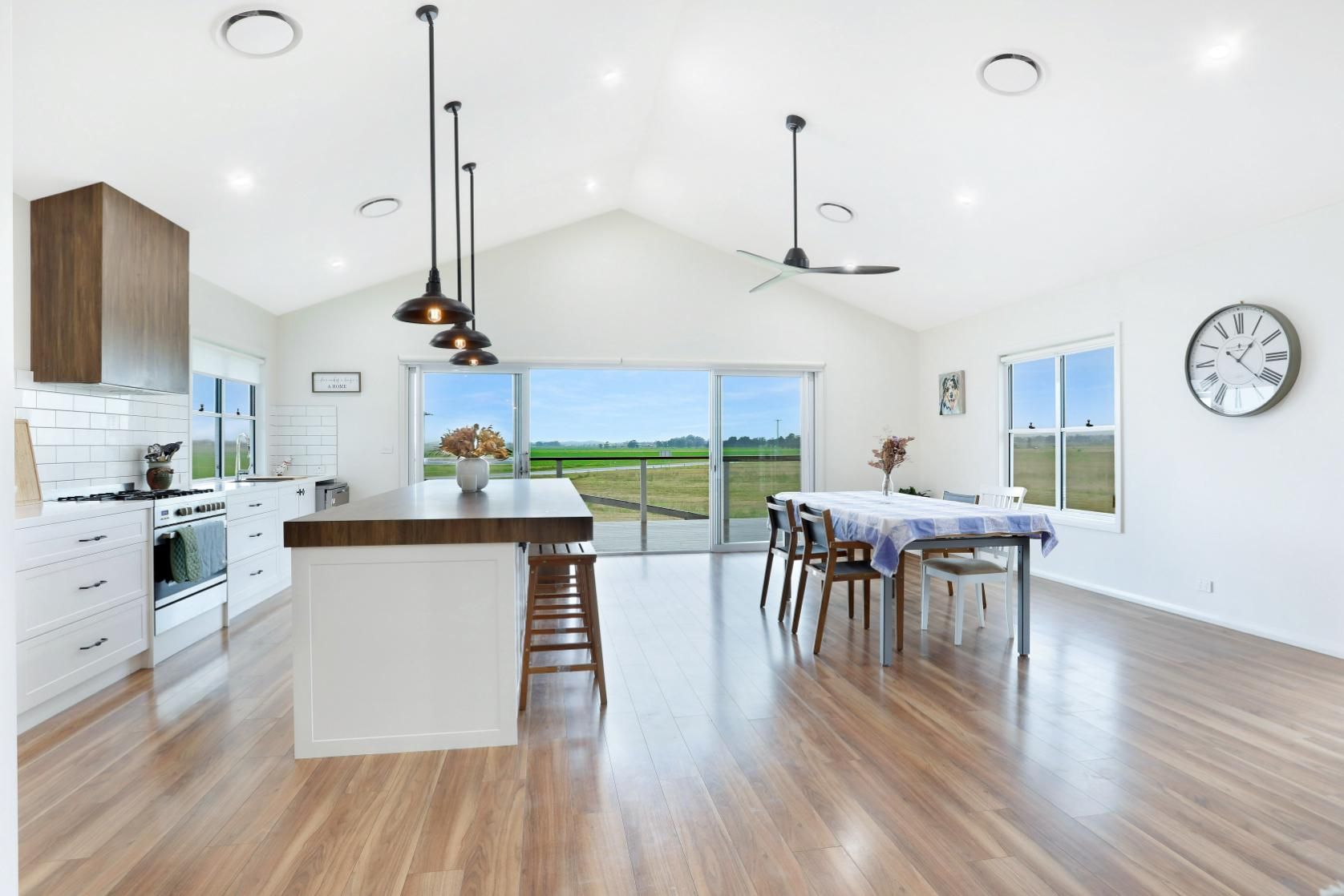 A Kitchen and Dining Room in A House with A Clock on The Wall — Jonobilt in Merewether, NSW