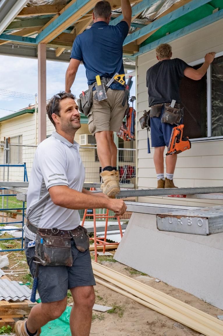 A Group of Men Are Working on A House — Jonobilt in Caves Beach, NSW