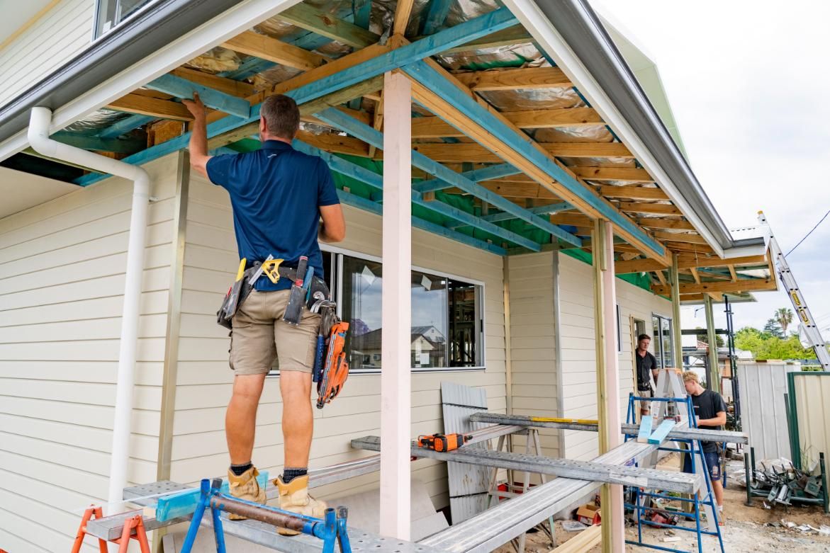 A Worksman is standing on stool and fixing ceiling of Pergola — Jonobilt in Bolwarra, NSW