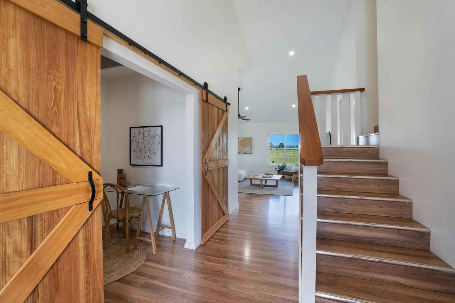 A Hallway with Wooden Floors and Stairs Leading up To the Second Floor — Jonobilt in Wallsend, NSW