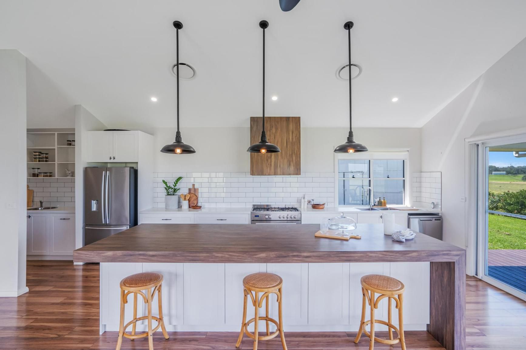 A Kitchen with A Large Island and Three Stools — Jonobilt in Cessnock, NSW