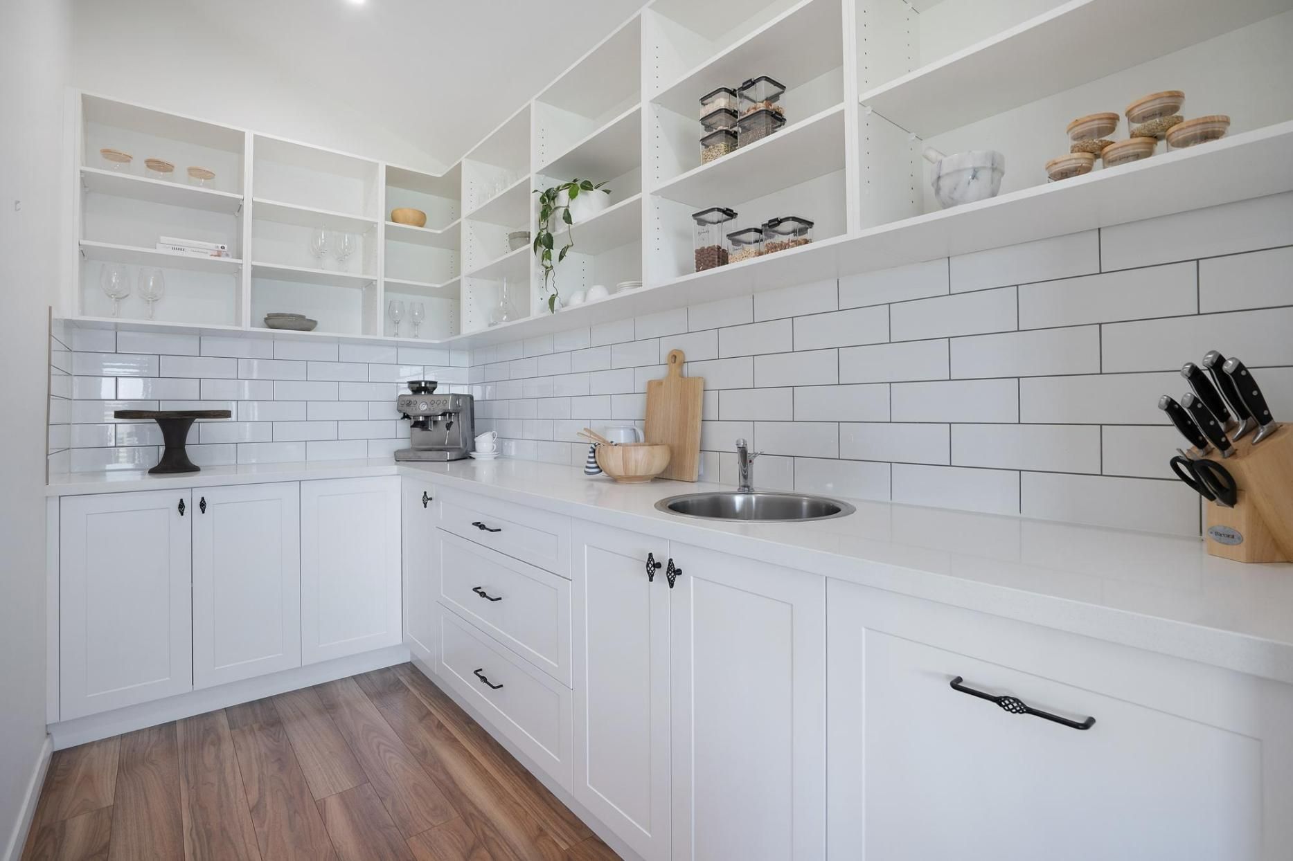 A Kitchen with White Cabinets, a Sink, and A Cutting Board — Jonobilt in Lake Macquarie, NSW