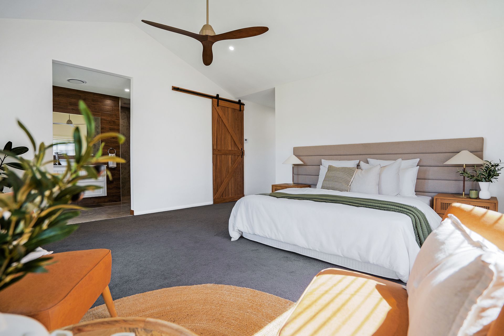 A Spacious Bedroom with Barndoor and Sunlight— Jonobilt in Bolwarra, NSW