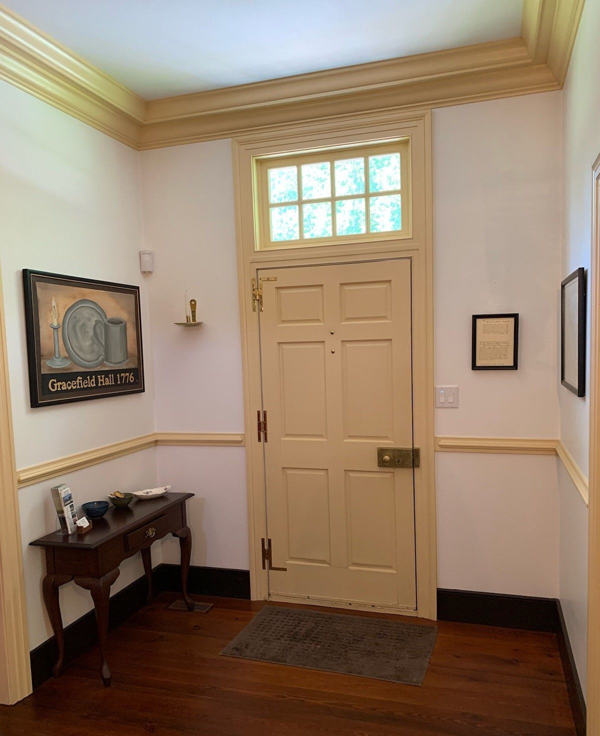 A hallway with a door and a table in it