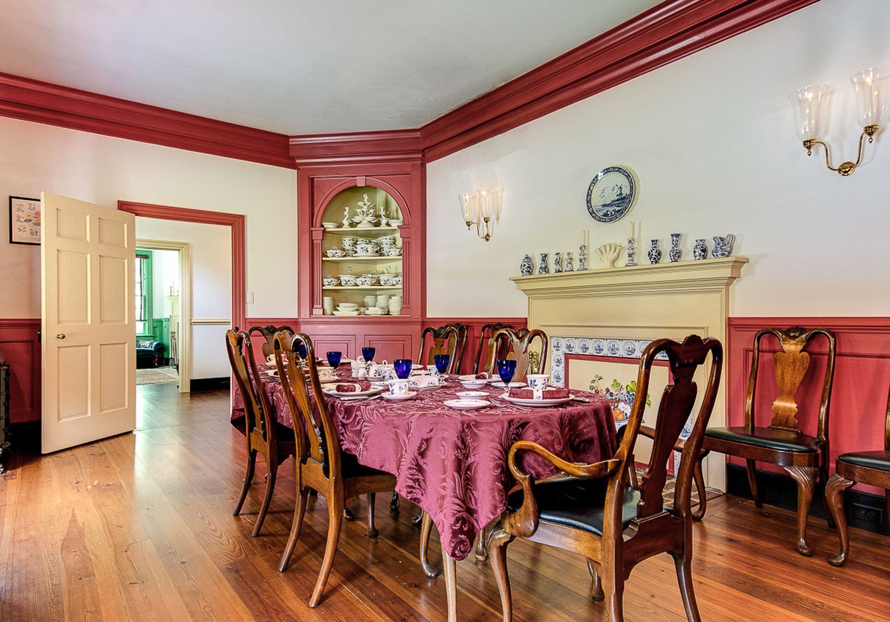 A dining room with a table and chairs and a fireplace.