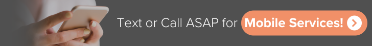 A person is holding a cell phone next to a button that says text or call asap for mobile services