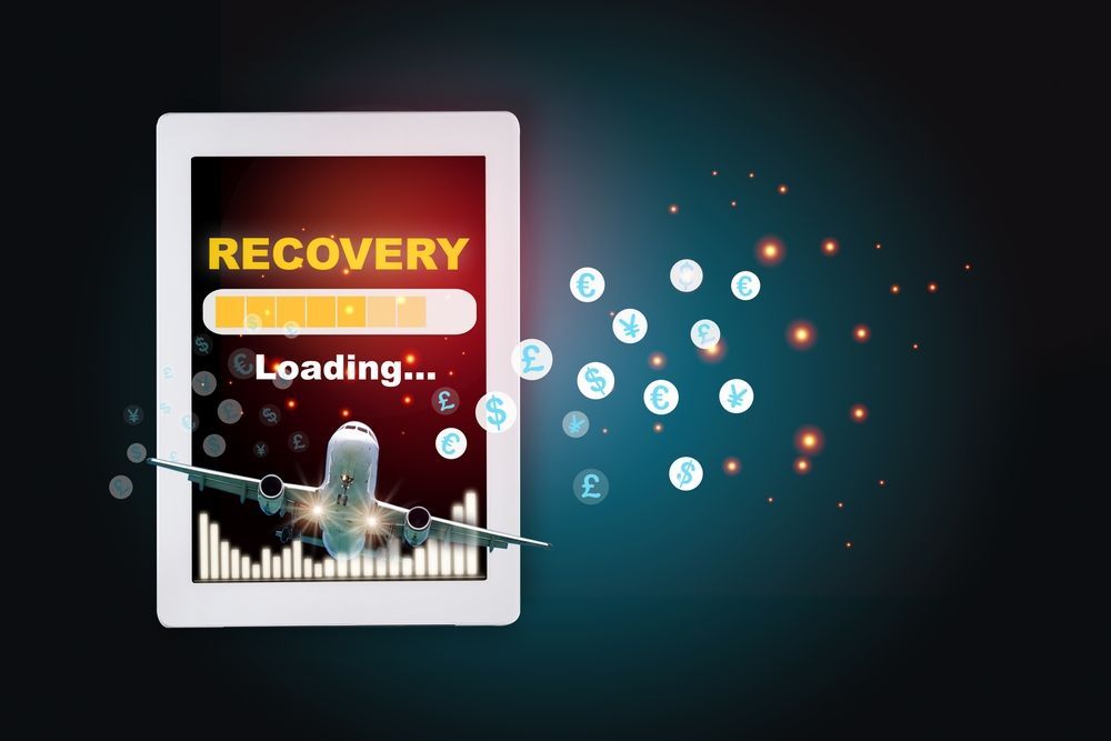 An airplane is flying out of a tablet screen that says recovery loading.
