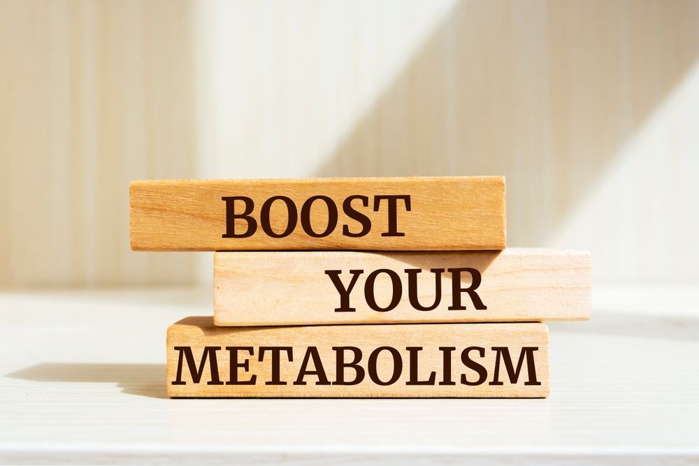 A stack of wooden blocks with the words `` boost your metabolism '' written on them.