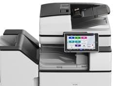 Office copier/printer with touchscreen control panel and attached paper tray, in gray and black.