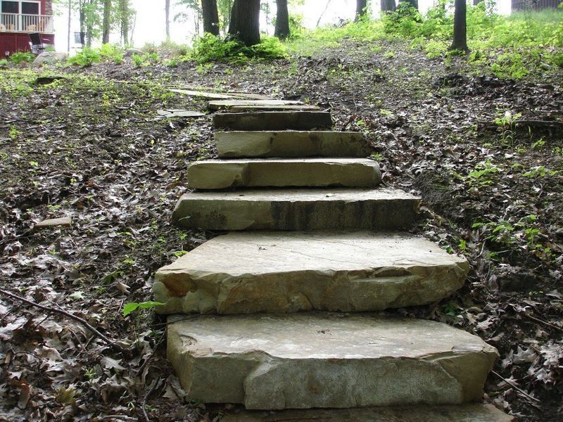 Stone steps ascending a wooded hillside.