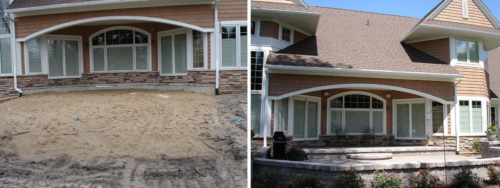 House exterior with dirt yard on the left, completed patio and landscaping on the right.