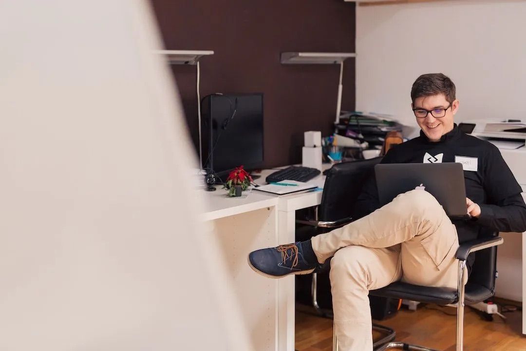 Man using a laptop for SEO and advertising work.
