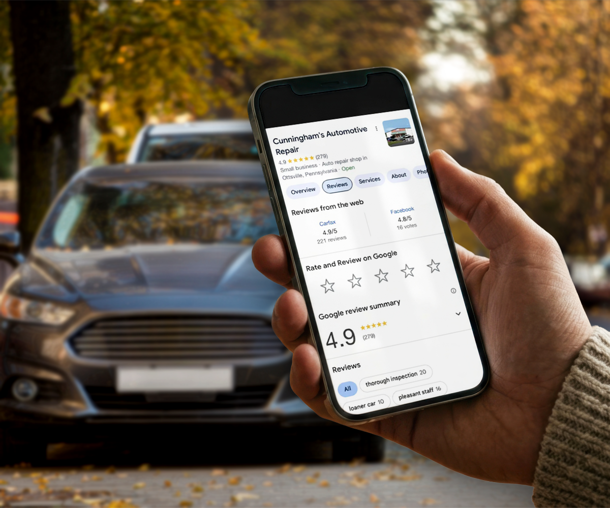 Hands holding a smartphone with a social media feed, with a white car blurred in the background.