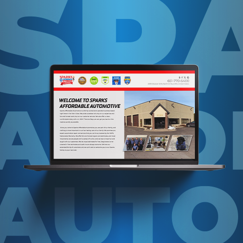 Laptop displaying an automotive website with a tan building photo on a blue background