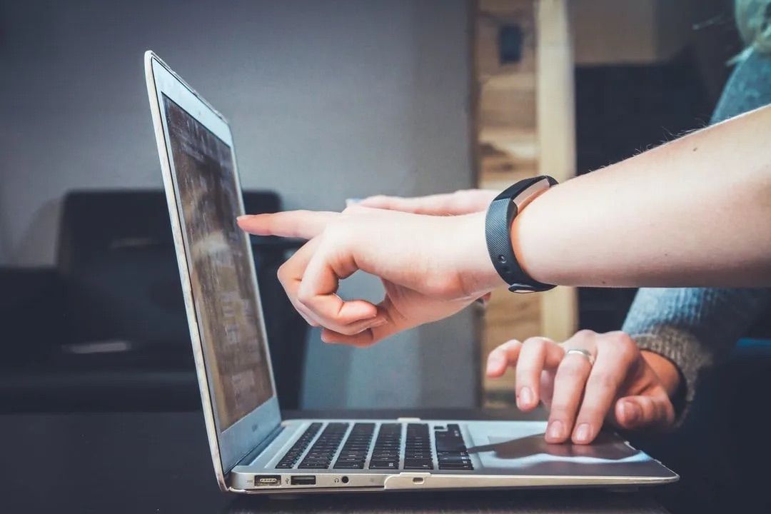 Person using a laptop to explore what is marketing automation: A Beginner's Guide.