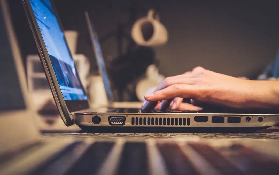 Person using a laptop to research why SEO for automotive is important.
