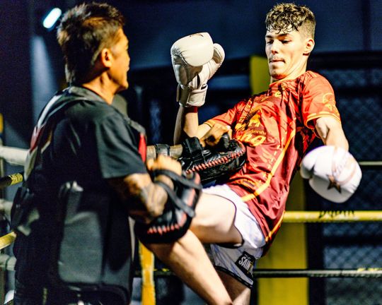 Muay Thai Coach working with Kings Student