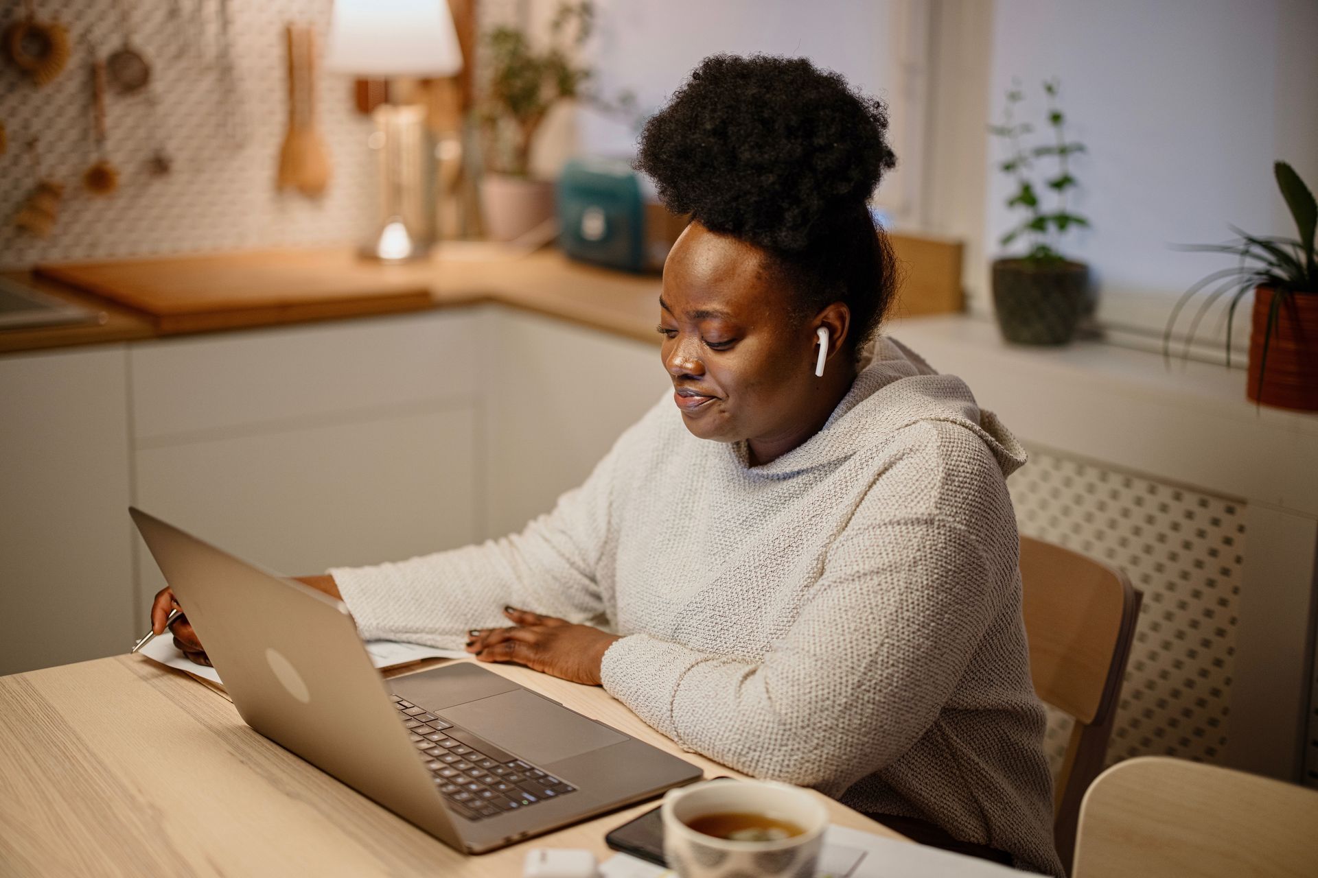 Woman looking at her laptop while on a telehealth call with her doctor