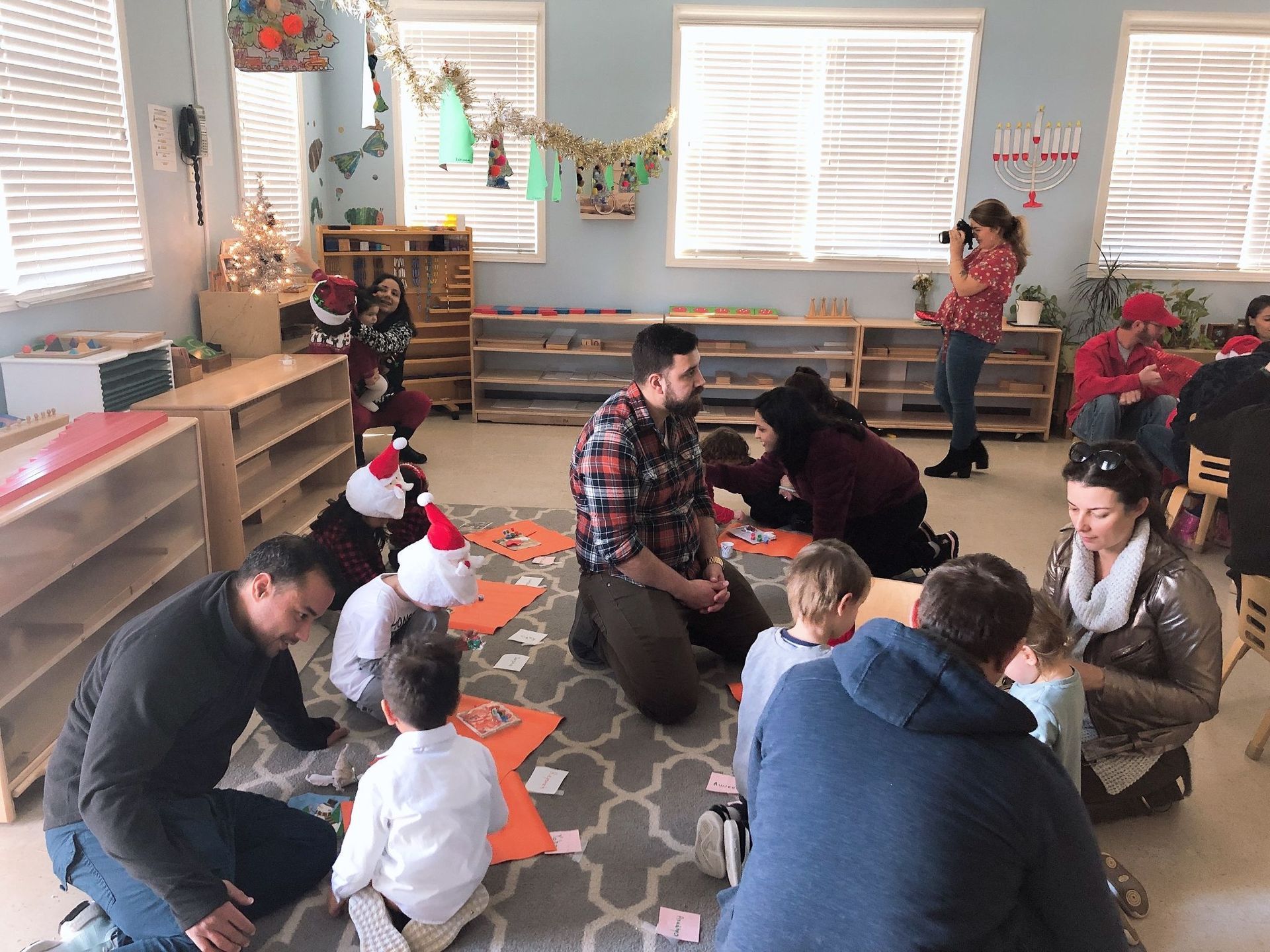 A group of people are sitting on the floor in a room.