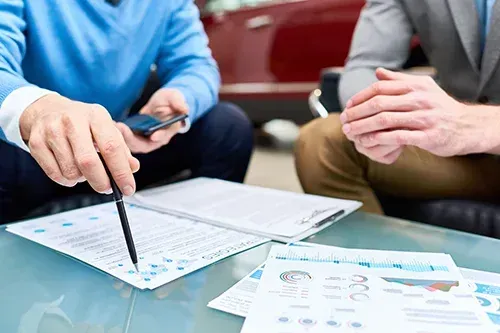 Two people discussing a business document