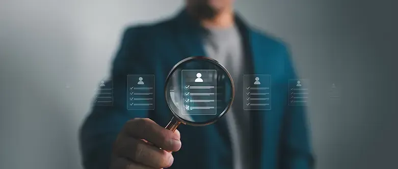 Employer counsel holding a magnifying glass examining an employee profile