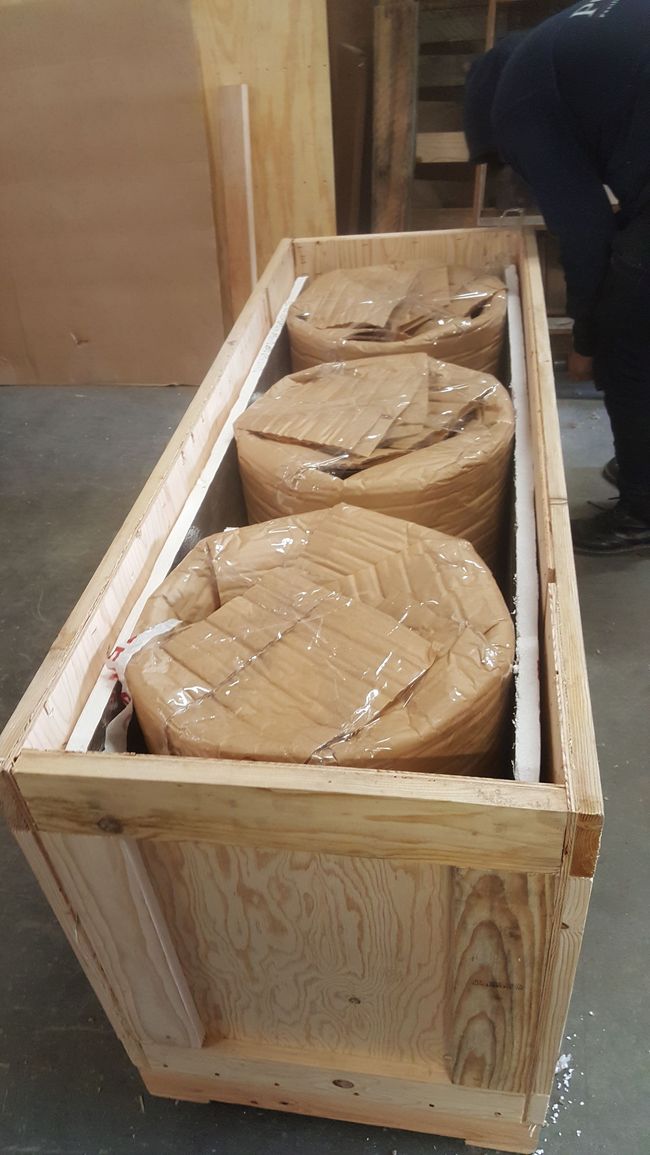 A wooden box filled with a bunch of boxes. Timely crating and shipping service.