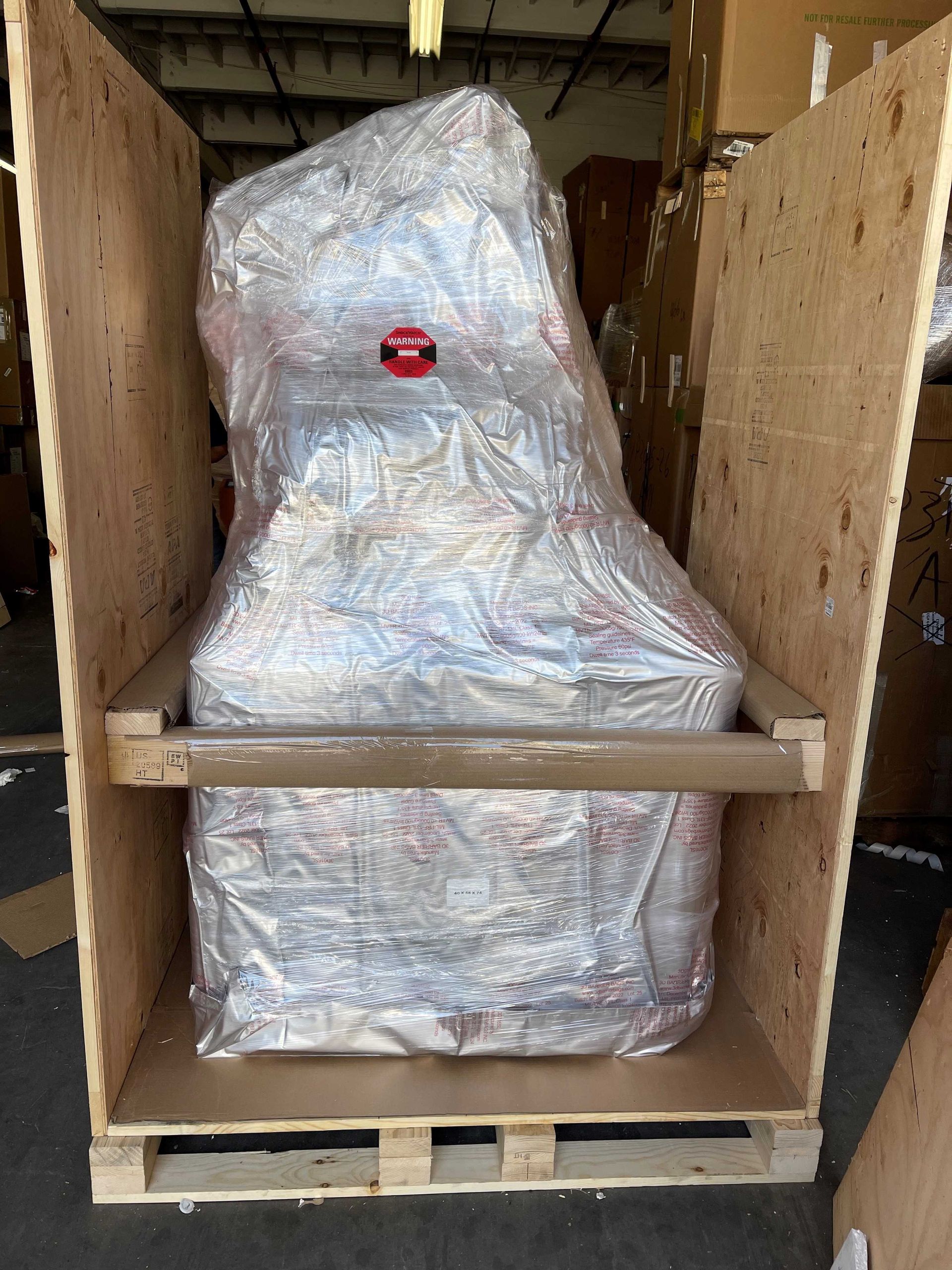 A large piece of plastic is wrapped in a wooden box. Efficient delivery for Electronics and Computer Equipment Shipping.