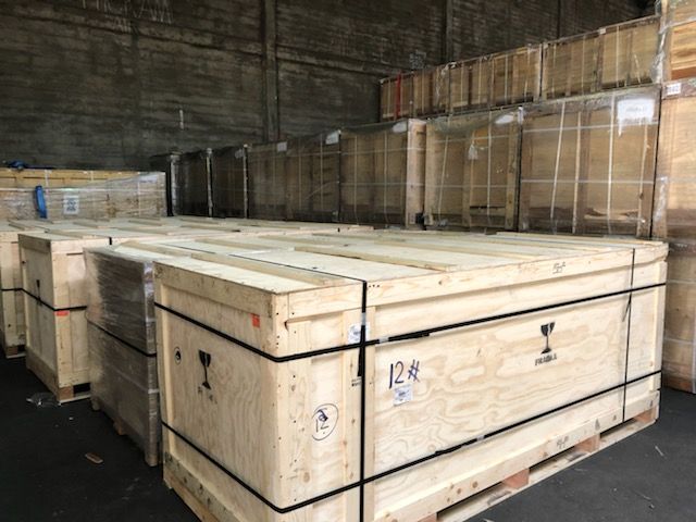 A warehouse filled with wooden crates and pallets.