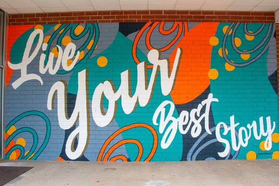 Mural of mules, farmer, tobacco farm, and pine trees in downtown Angier, North Carolina by Elyse Johnson
