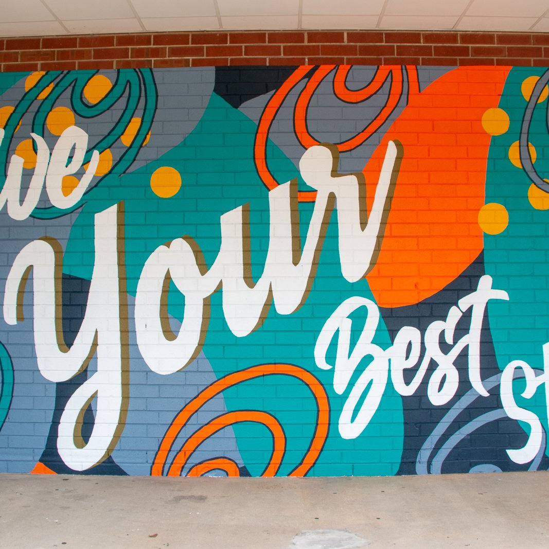 Flower mural around storefront of Simply Decor in downtown Angier, North Carolina by Elyse Johnson