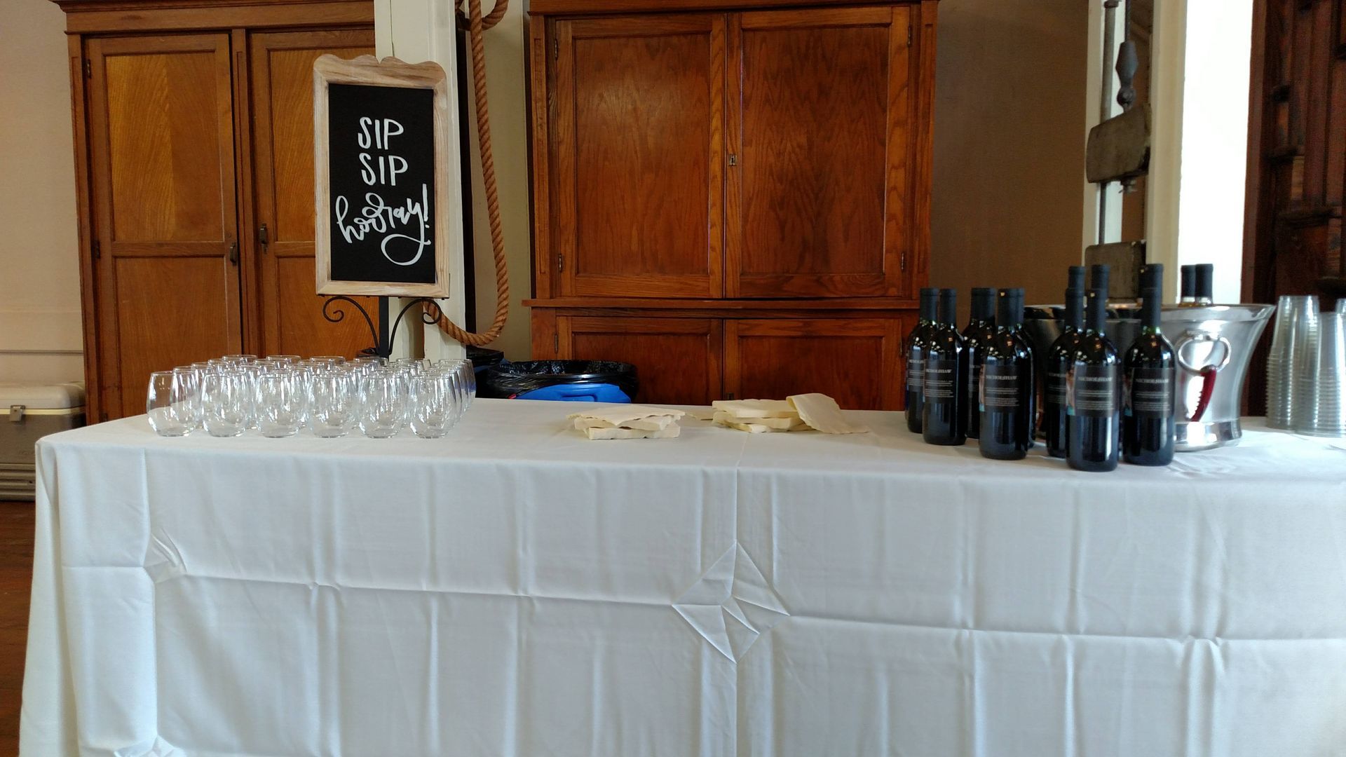 A table with bottles of wine and glasses on it