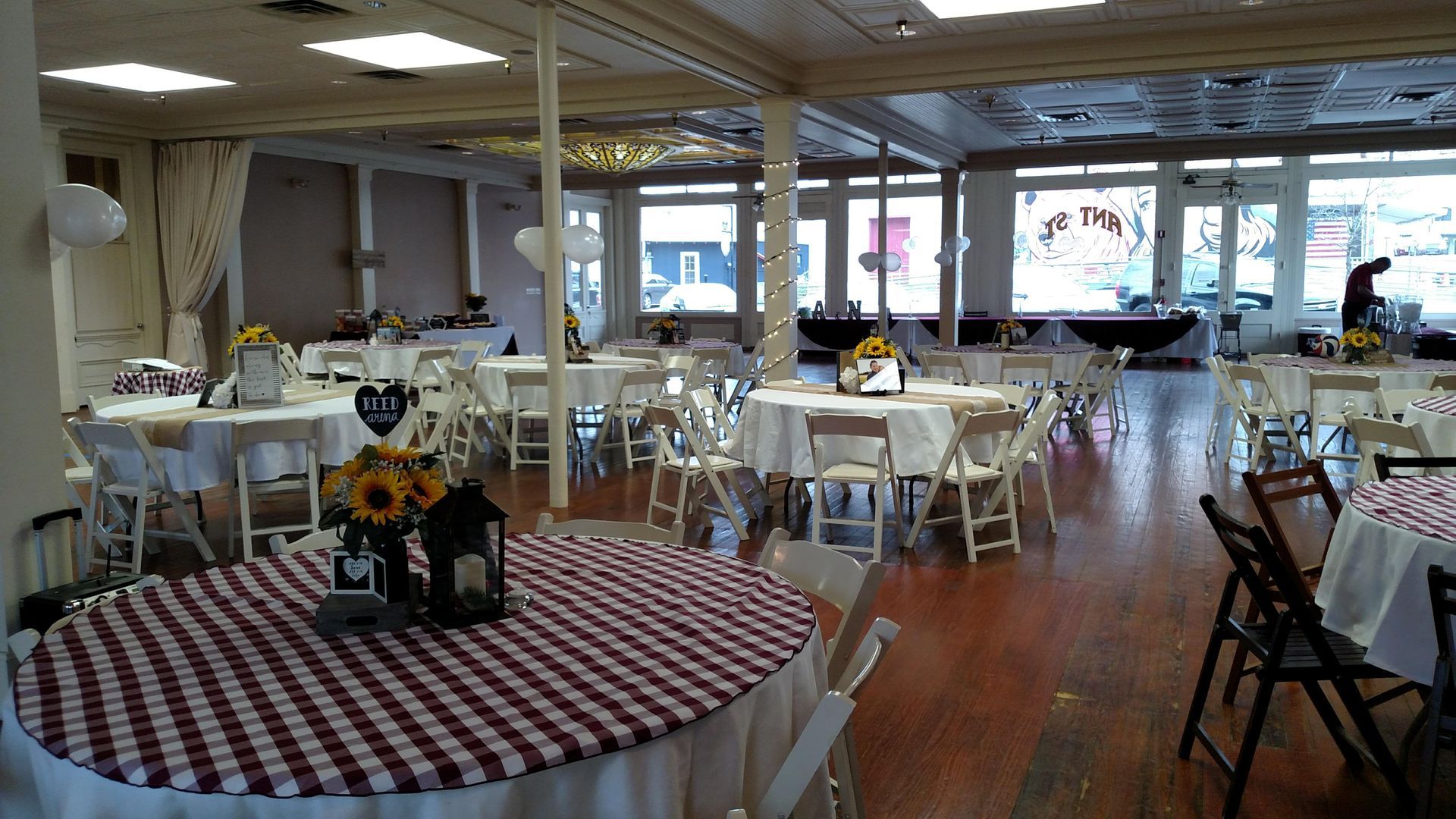 A large room with tables and chairs set up for a party