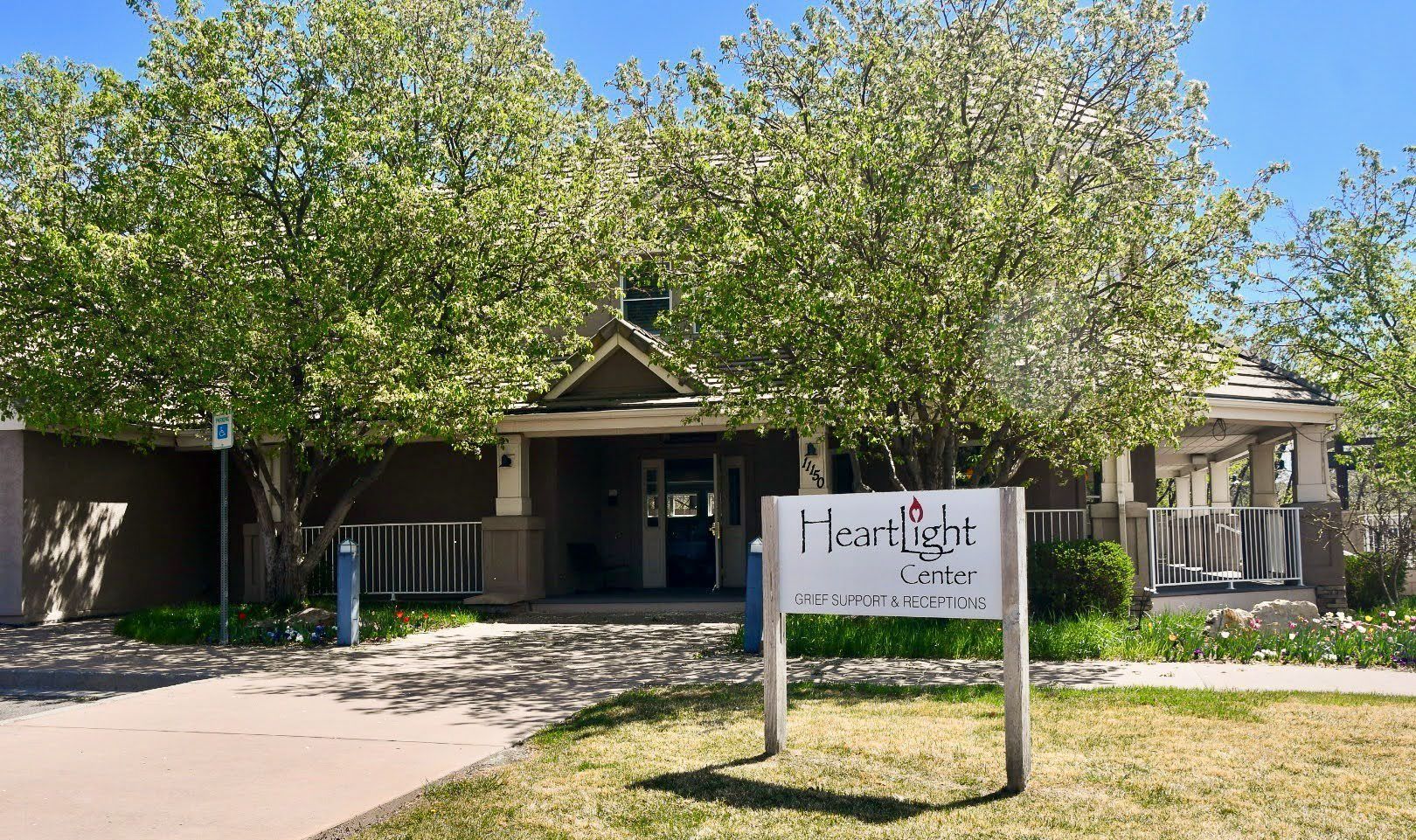 Front entrance of a building with trees and a sign reading “The Cove” in the foreground.