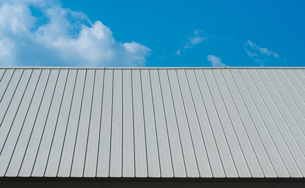 Metal Roof With Vertical Lines Against a Bright Blue Sky — GCX Roofing In Brisbane, QLD