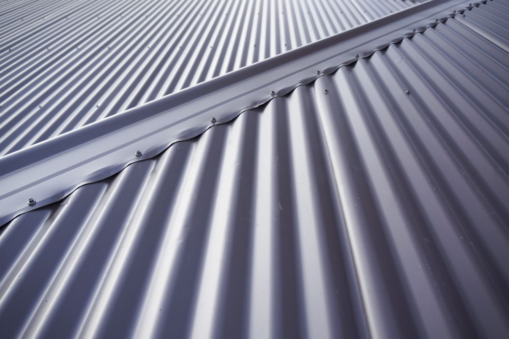 Corrugated metal roof, silvery-grey, with a central ridge.