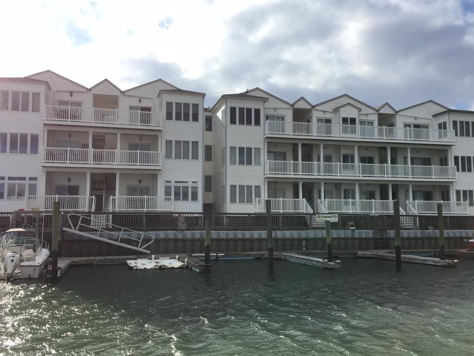 exterior remodel of white waterfront townhouses with boat docks in sea isle city, new jersey done by j.k. construction llc