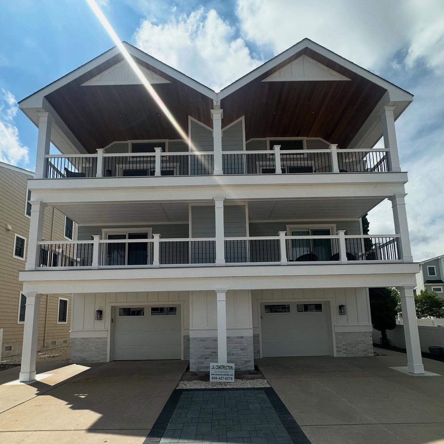 exterior renovation of a two-story duplex beach house with garages and balconies in avalon, new jersey