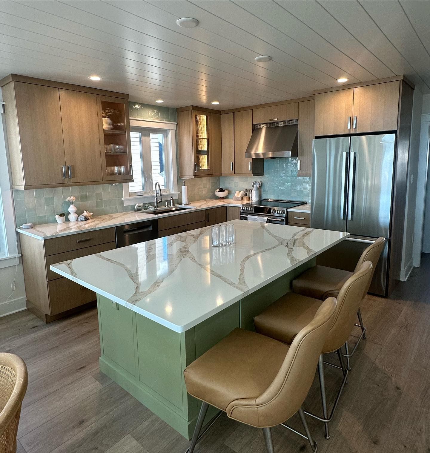 Kitchen with large white island countertop, wooden cabinets, and turquoise backsplash remodeled by j.k. construction llc in ocean city, new jersey