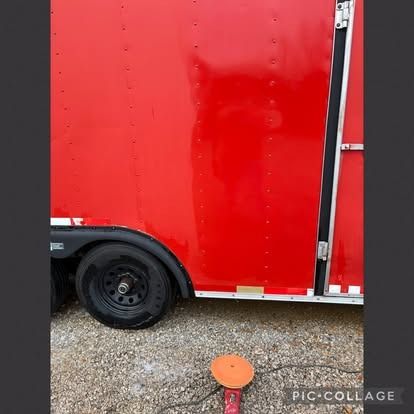 Red trailer with black wheel and a polishing tool on the ground.