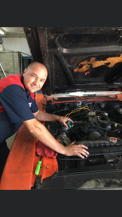 Mechanic working on a vintage car engine | Mr. Fix It Auto Repair