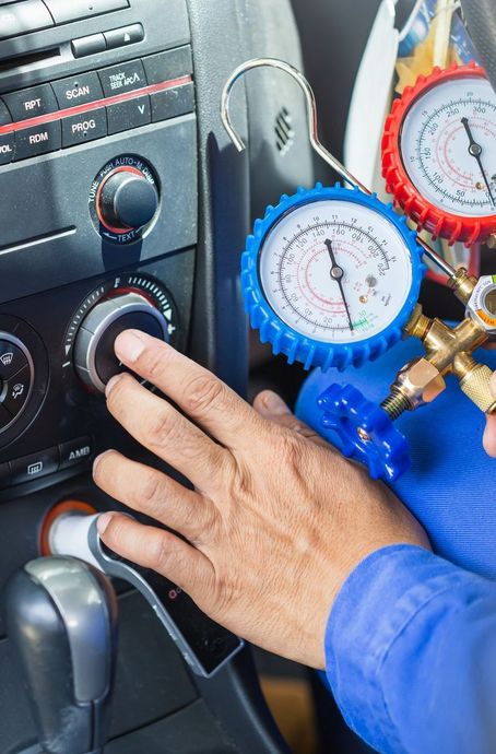 Mechanic's hand adjusting a car's climate control | Mr. Fix It Auto Repair