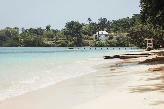 A beach with a lifeguard tower in the distance