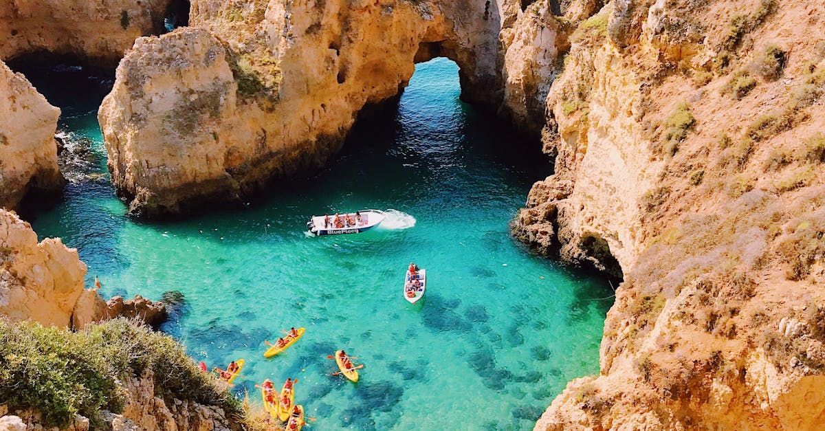 A group of people are kayaking in a small body of water surrounded by rocks.
