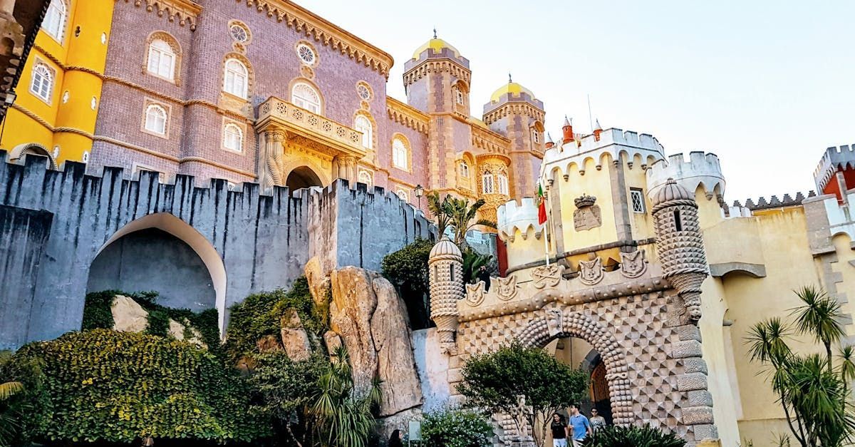 A large castle sitting on top of a hill surrounded by trees.