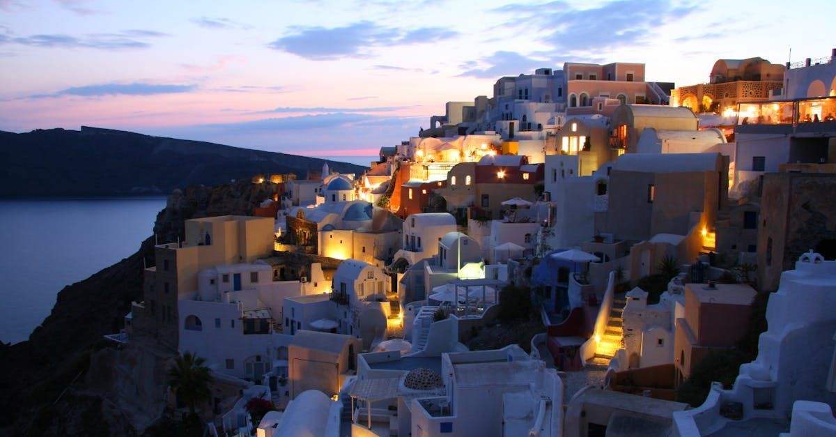 A small town on a hill overlooking the ocean at night